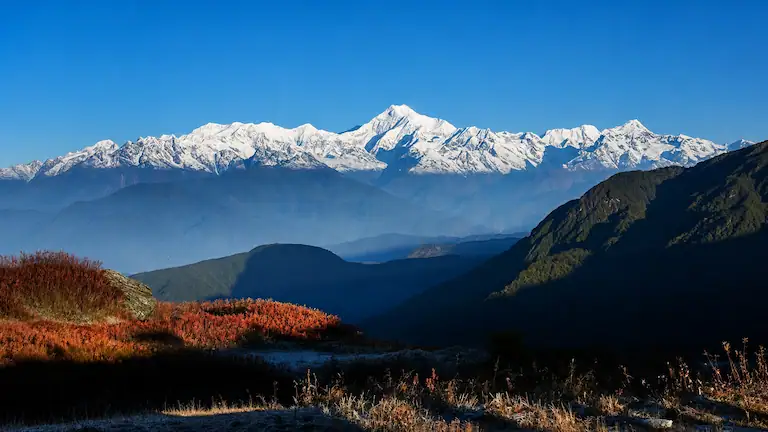 Clear morning view of the snow-capped Kanchenjunga mountain range from Ghoom Rock.
