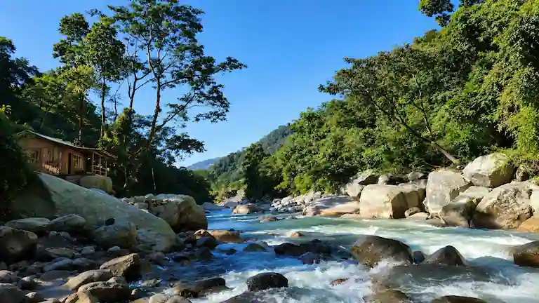 Wooden homestay by the rushing Rangpo Chu river in Rolep, Sikkim.