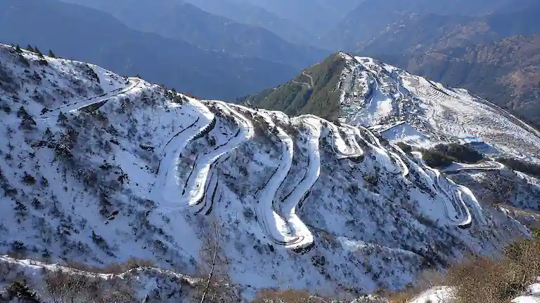 Snow-covered winding Zuluk Loops on the Old Silk Route in East Sikkim.