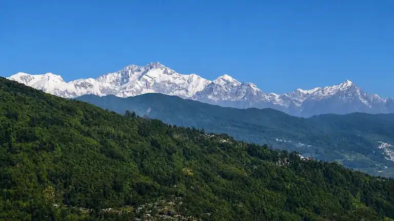 A clear panoramic view of the snow-capped Kanchenjunga mountain range from Ahaldara.