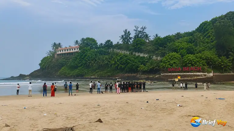 Ground reality crowd levels and the iconic red sign at Baga beach, one of the famous north goa beaches.