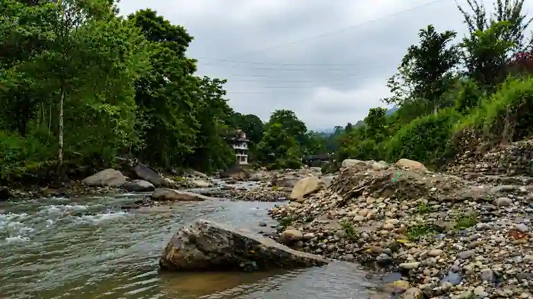 The clear Rangbhang River flowing through the scenic Tabakoshi valley.