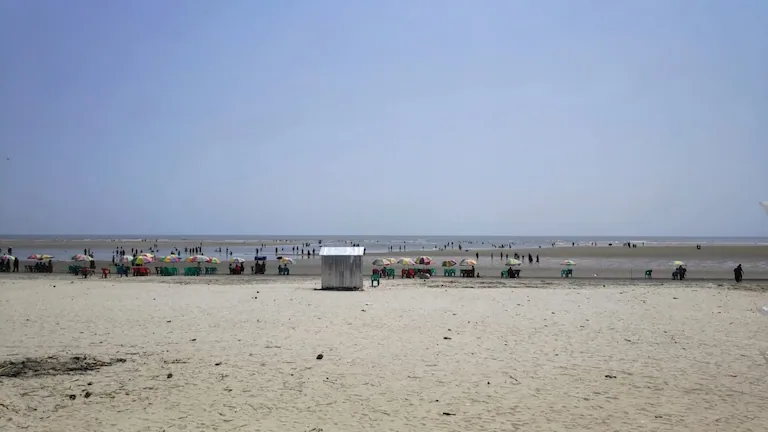 Wide view of Bakkhali beach during low tide showing hard-packed sand, the final stop after driving the Kolkata to Bakkhali distance.