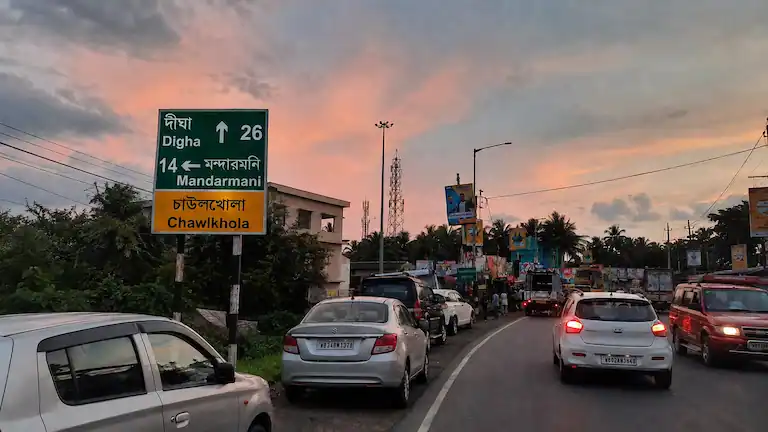 Green highway signboard at Chaulkhola junction showing the true Chaulkhola to Mandarmani distance.