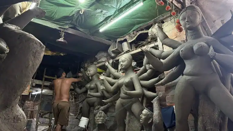 Artisan making clay idols in Kumartuli during Kolkata Heritage Walks.