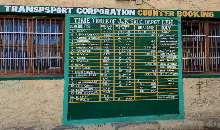 The official J&K SRTC counter booking board and timetable at the Leh Bus Depot.