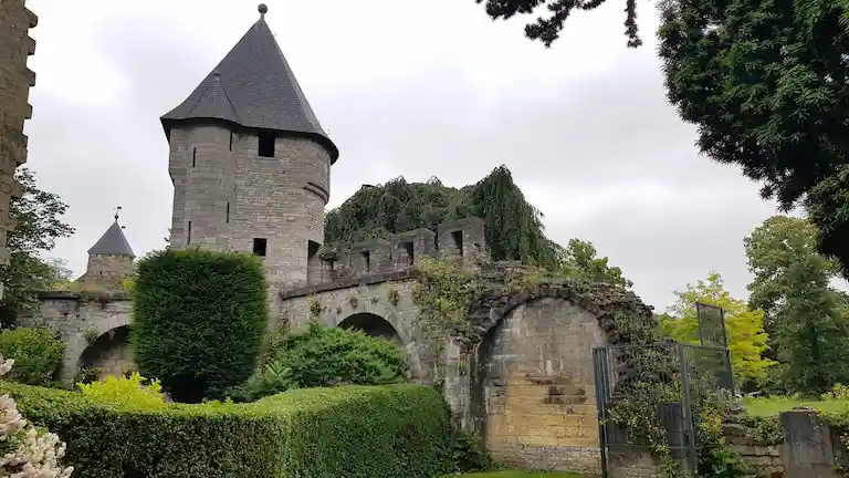 The historic stone walls and defense tower surrounded by green parks in the Jekerkwartier of Maastricht.