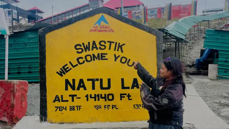 Official Project Swastik yellow milestone at Nathula Pass showing the 14,140 feet altitude.