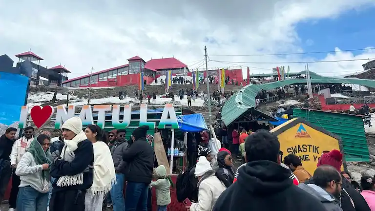 Tourists climbing steep stairs after paying the Nathula Pass permit cost at the Sikkim border.