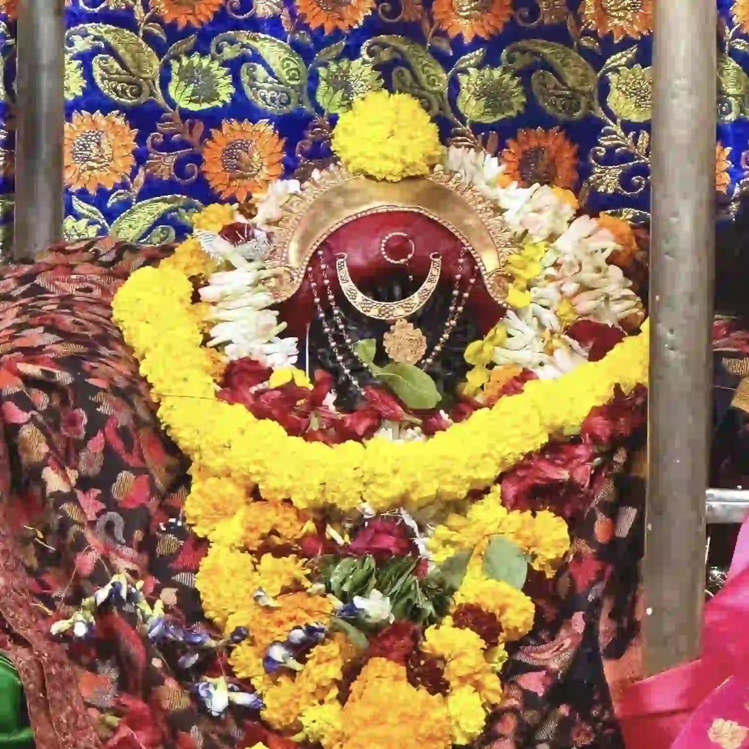1,000-year-old 18-armed Sarbamangala idol adorned with flowers.