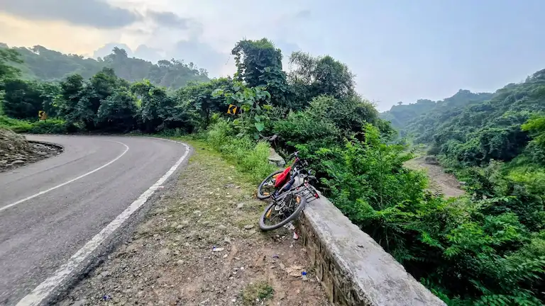 Sharp curve with loose gravel on the mountain road during the Chandigarh to Morni Hills drive.