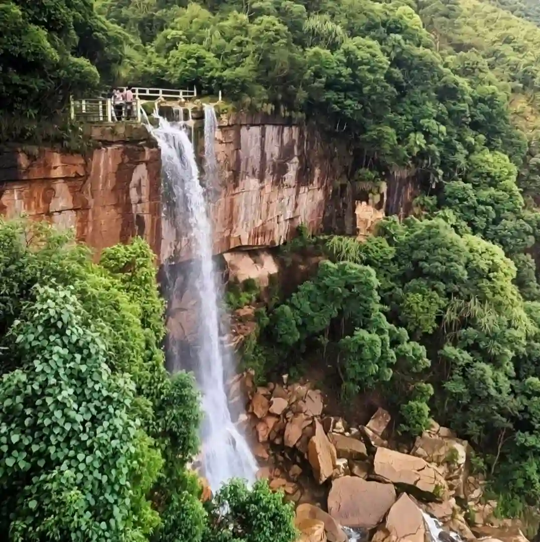 Tall waterfall dropping directly off a steep cliff in Cherrapunji