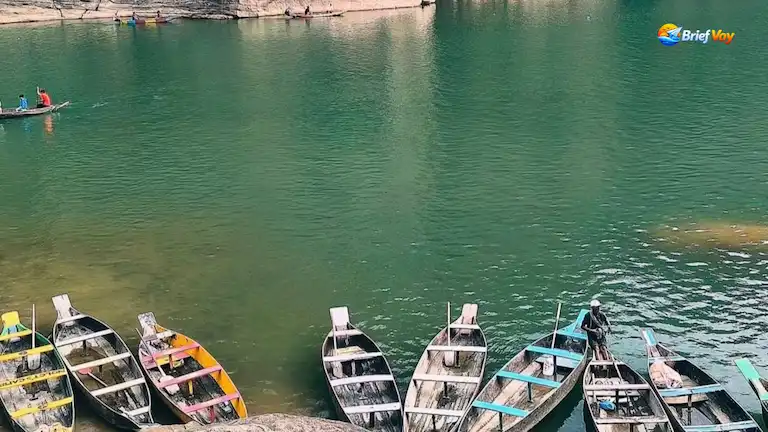 Wooden boats on the clear Dawki river during the best time to visit Meghalaya
