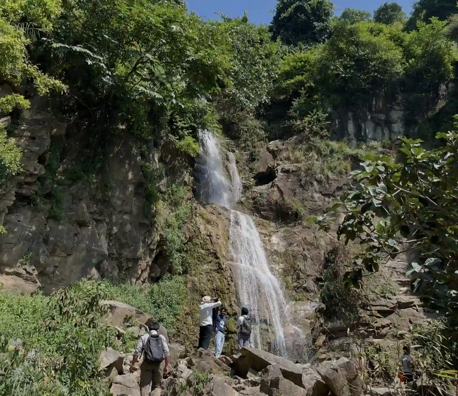 Seasonal waterfall cascading down rocky cliffs in Morni Hills, Haryana.