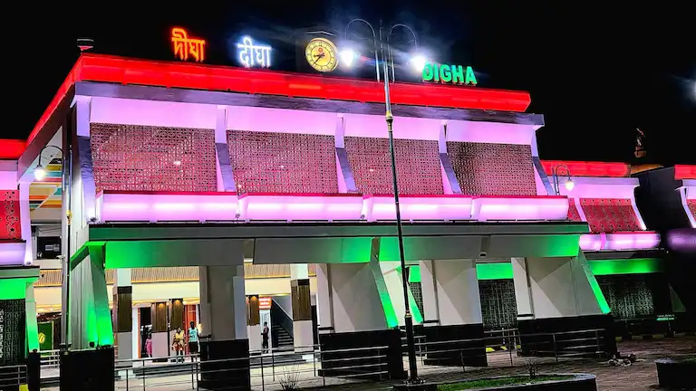 New Digha Railway Station exterior lit up at night.