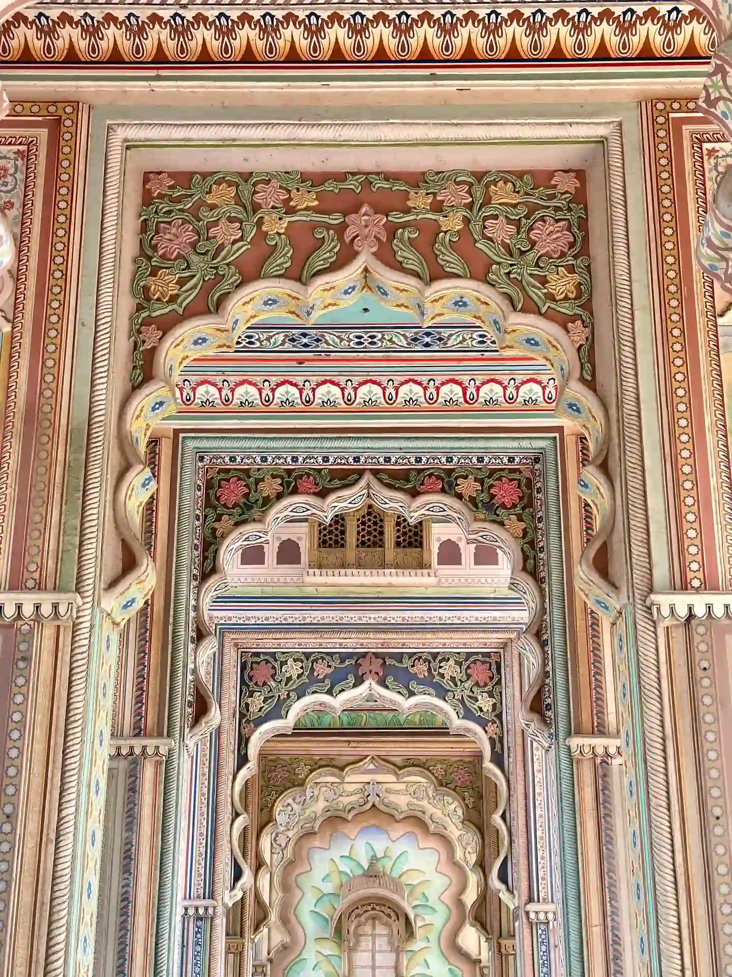 Colorful painted arches and intricate floral artwork inside Patrika Gate, Jaipur.